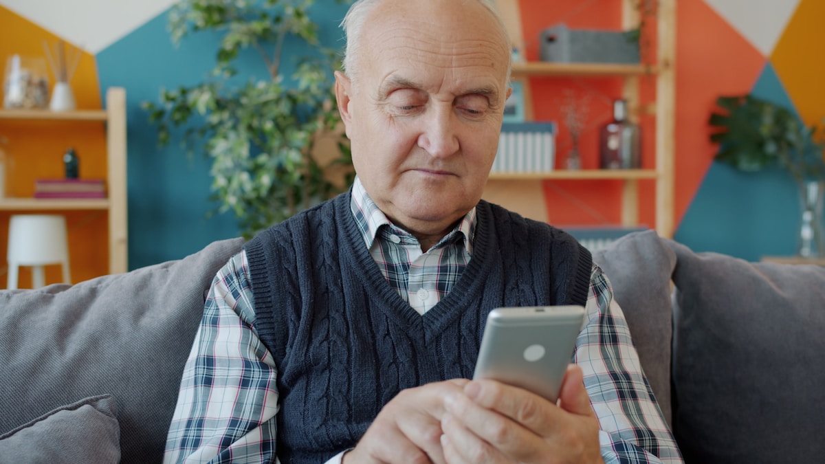 Man looking at smartphone — Social Security text scam warning